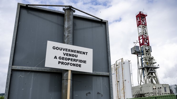 En Suisse, la géothermie a du mal à s'imposer: Une pancarte devant le chantier lors d'une manifestation contre le projet de geothermie profonde a Haute-Sorne en mai 2024 a Glovelier.